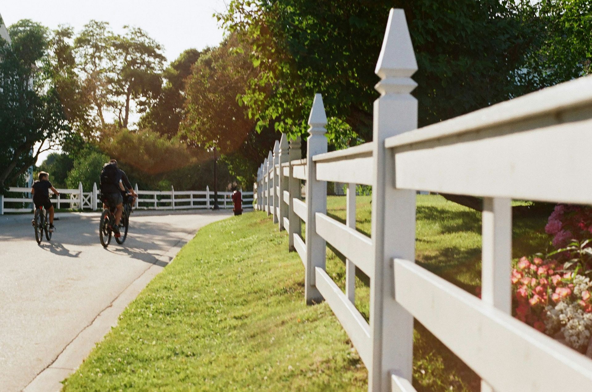 a couple of people riding bikes down a street
